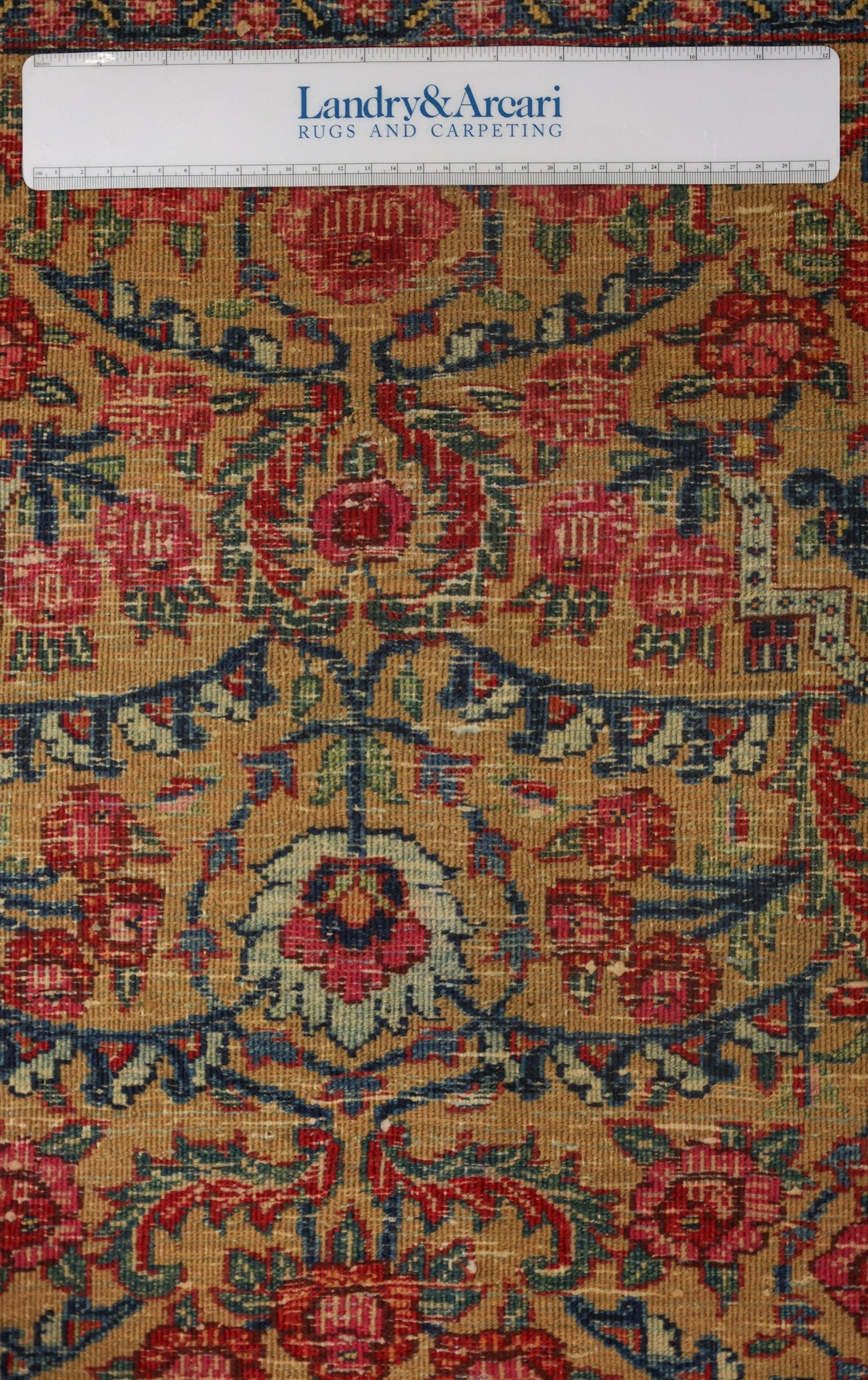 Close-up detail of an antique Bijar rug's intricate floral pattern, showcasing its handwoven texture and muted color palette.