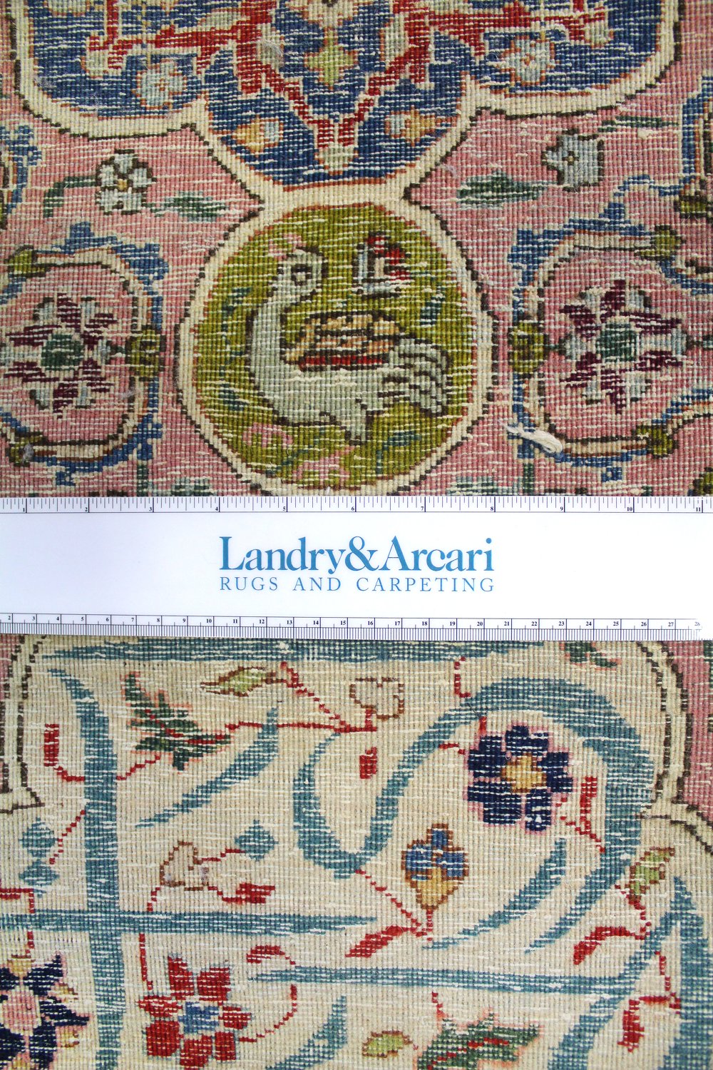Close-up detail of antique Tabriz rug, showcasing intricate floral and bird motifs in muted pinks, blues, and greens.