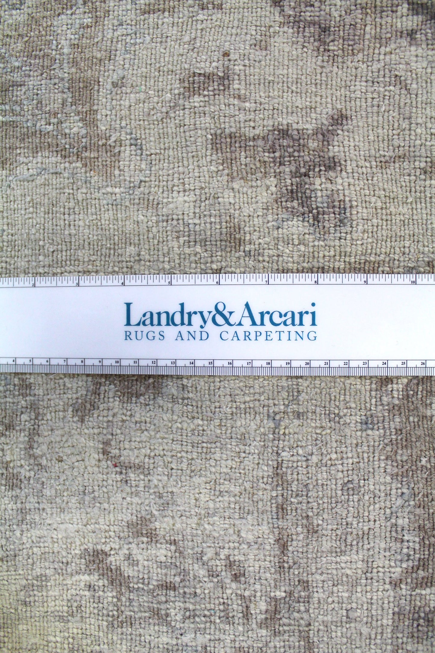 Close-up of handwoven rug texture, showing neutral tones and detailed craftsmanship.