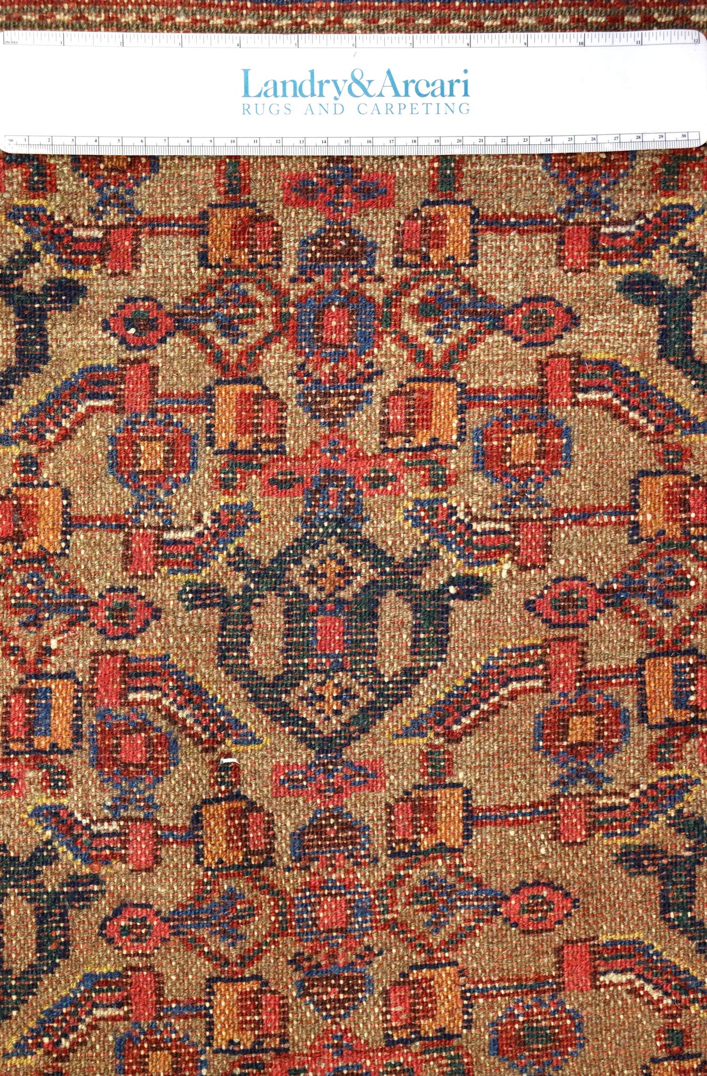 Close-up of antique Hamadan rug detail, showcasing intricate camel hair weave and vibrant colors.