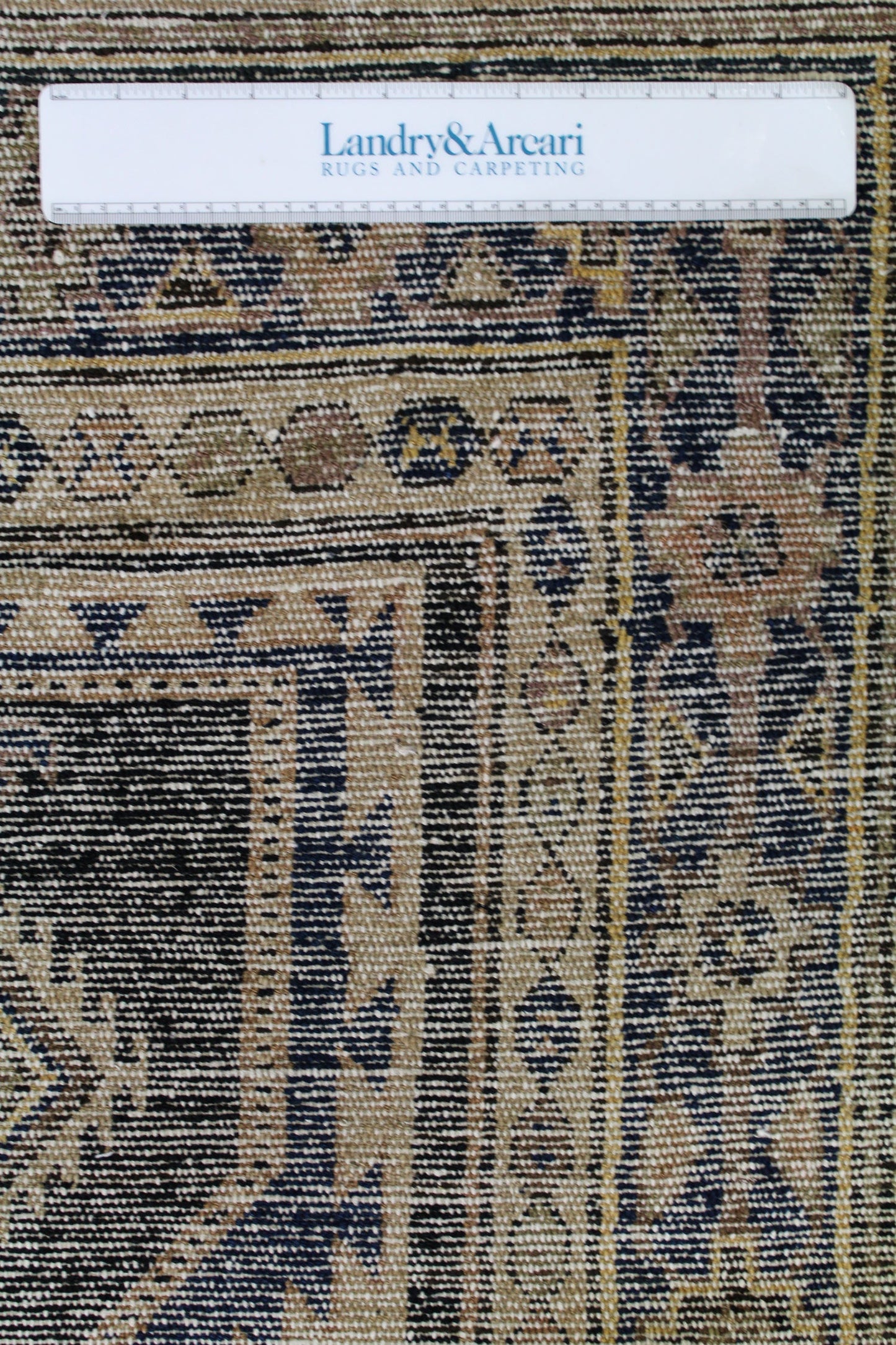 Close-up detail of antique Malayer rug's handwoven texture, showcasing its intricate, earthy color palette.
