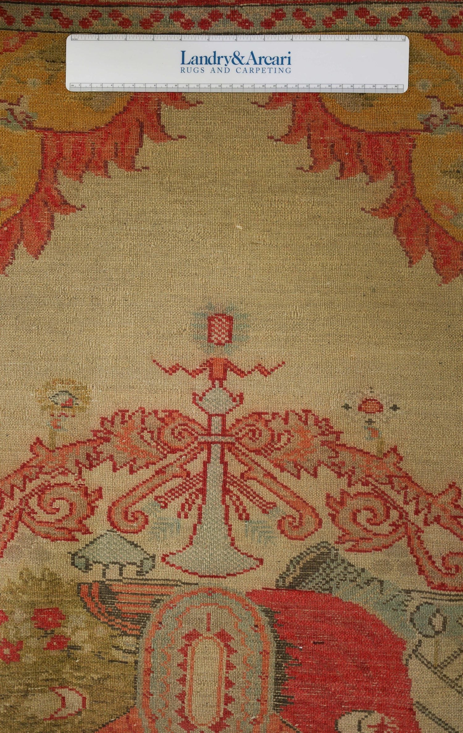 Handwoven rug detail: antique Ottoman shield design, muted reds and beige tones.
