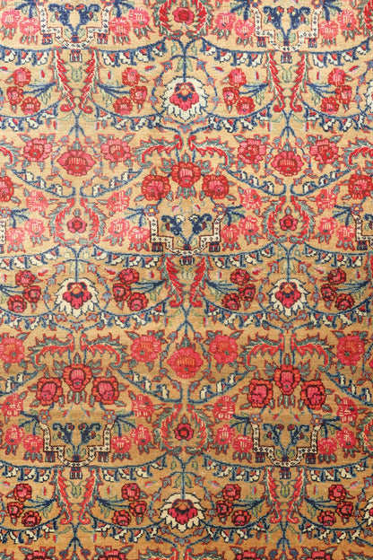 Antique rug detail:  Handwoven Bijar tribal design with floral and botanical motifs in red, blue, and beige.
