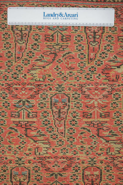 Close-up detail of antique tribal rug's handwoven red and black pattern.
