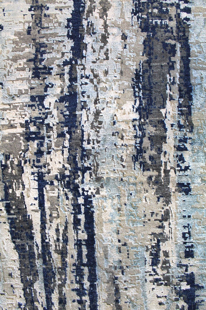 Handwoven rug detail: abstract blue, gray, and beige pattern.
