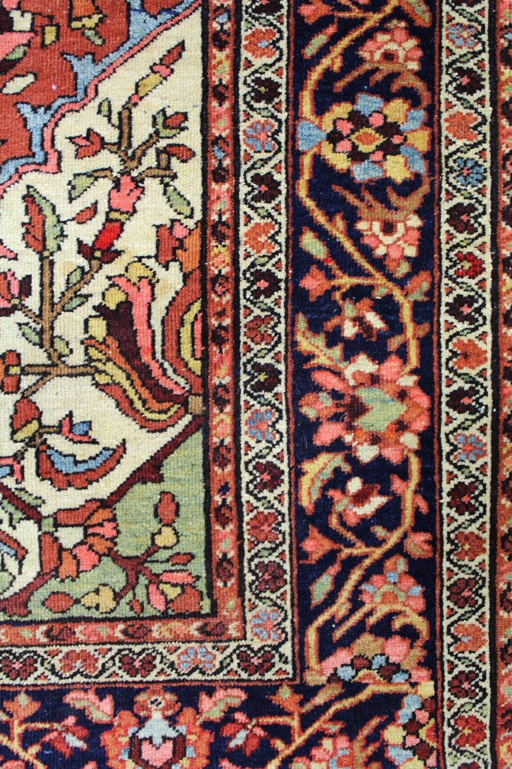 Handwoven rug detail:  Floral border, cream & navy tones, antique Ferahan Sarouk design.
