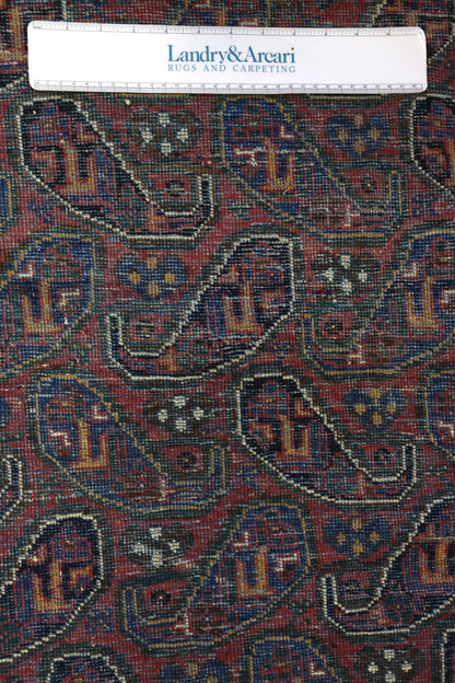 Close-up detail of an antique Afshar rug's intricate, multicolored paisley pattern.
