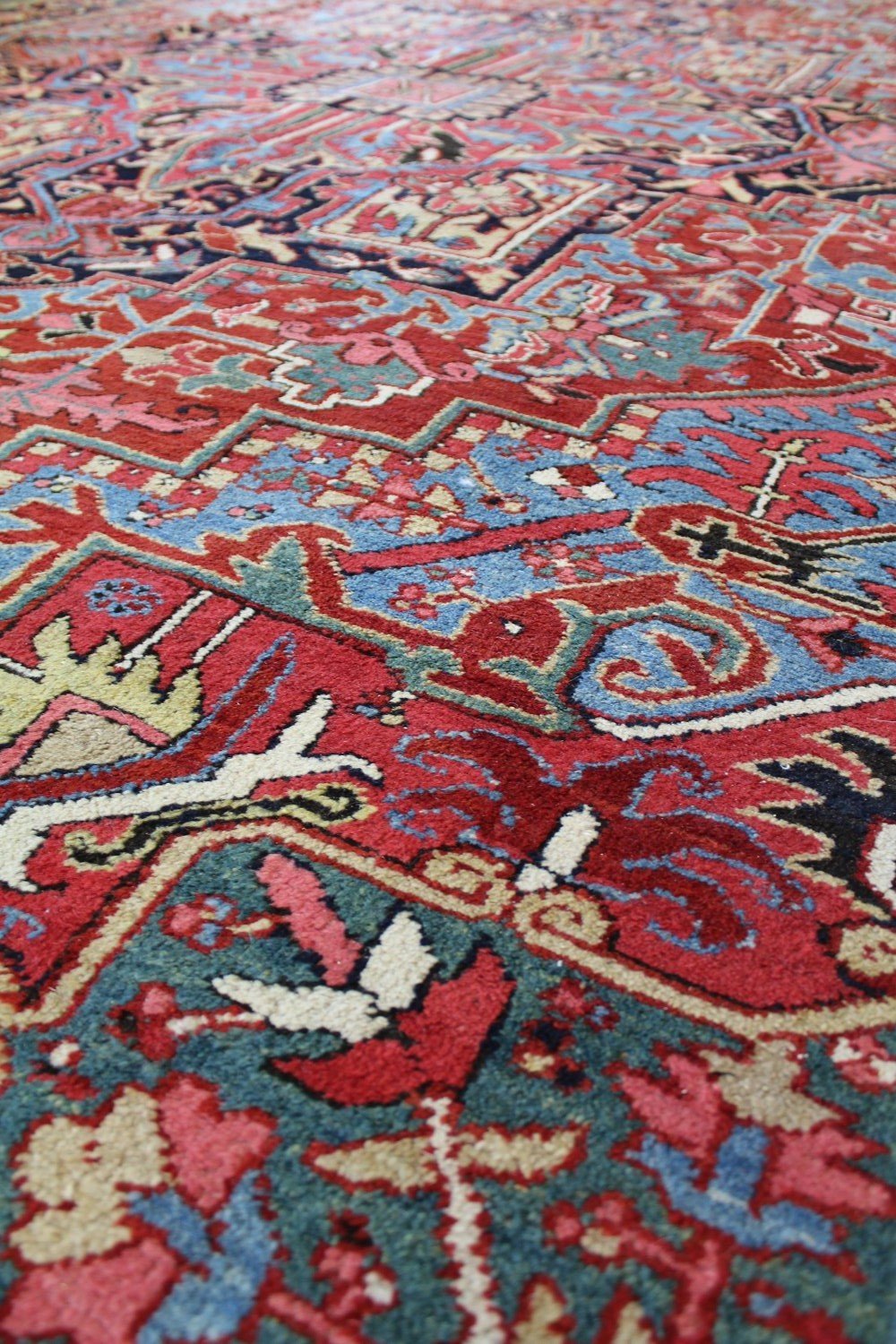 Close-up detail of a vintage Heriz rug showcasing its intricate, multicolored pattern.
